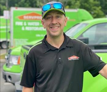 SERVPRO employee in uniform with hat and sunglasses on his head
